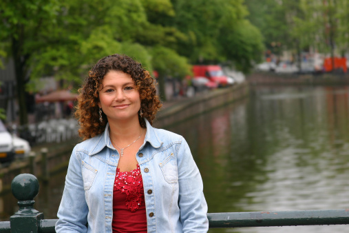 Smiling Tunesian girl in front of a canal in Amsterdam