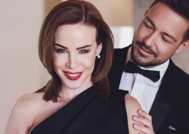 istock Rich confident cougar woman with younger man 1395348441
