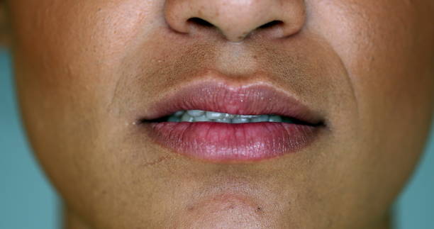 istock Black woman changing mood. close-up mouth changes emotion 1395353322