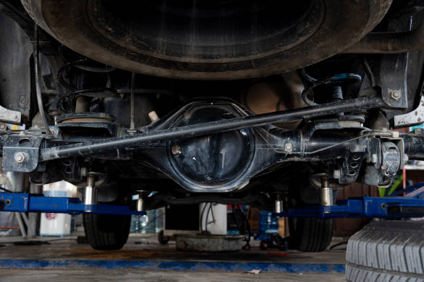 Manitenance background of car's suspension reveals the rear drive shaft. stock photo
