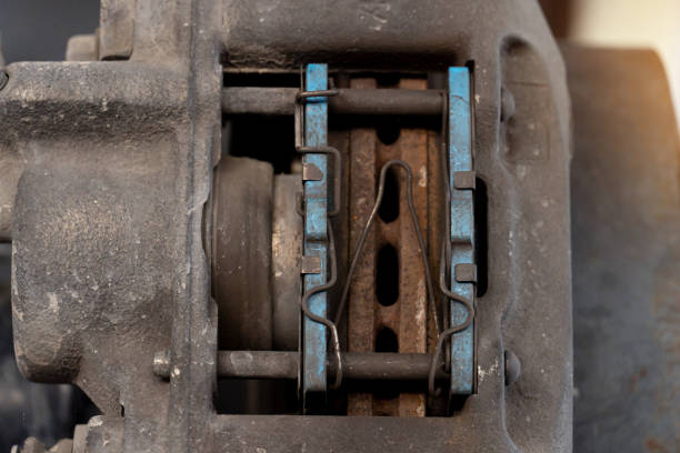 Close-up view of the inside of a caliper with used of breaker pads. stock photo