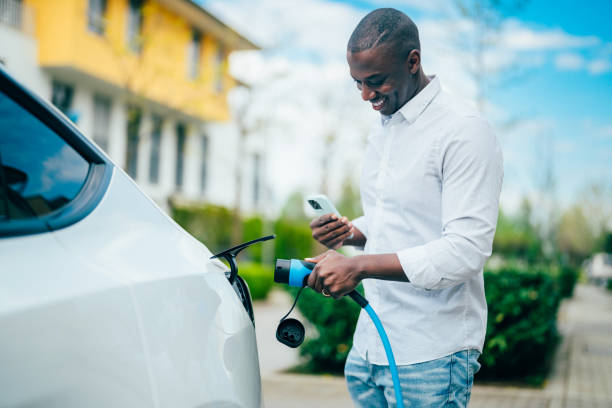 istock Man charging electric car 1395353424