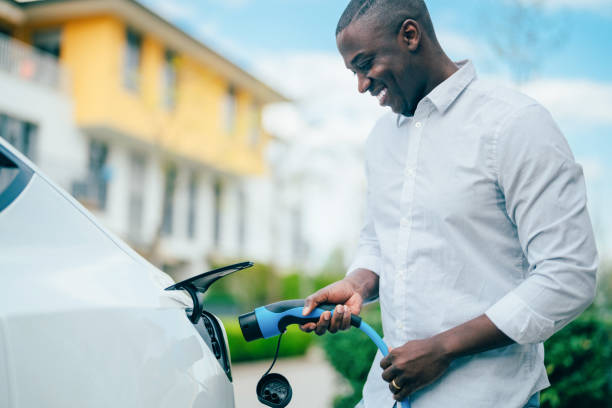 istock Man charging electric car 1395353459