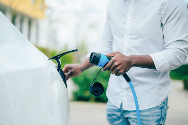 istock Man charging electric car 1395353490