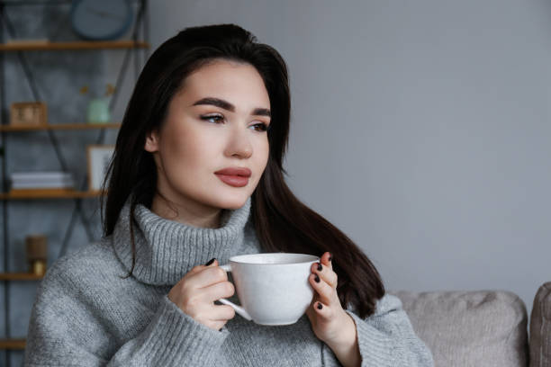 istock Young woman alone at home. 1395353569