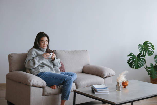 istock Young woman alone at home. 1395354260