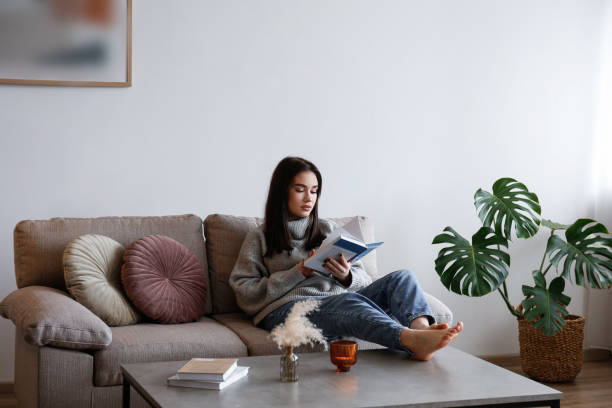 istock Young woman alone at home. 1395354315