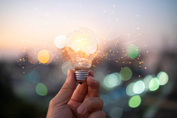 istock Businessman holding glowing lightbulb with drawing brain and connection line, creative thinking ideas 1395354431