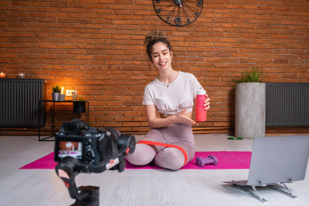 istock Female personal trainer, recording on camera her homeworkout 1395354515
