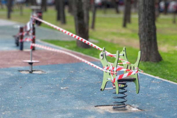 istock Children's playground blocked by barricade tape 1395355134