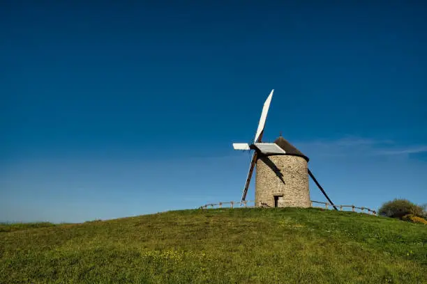 the Moidrey windmill in Pontorson in Normandie on a sunny day with blue sky