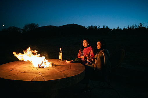Couple on vacation in a rented house in the countryside, campfire