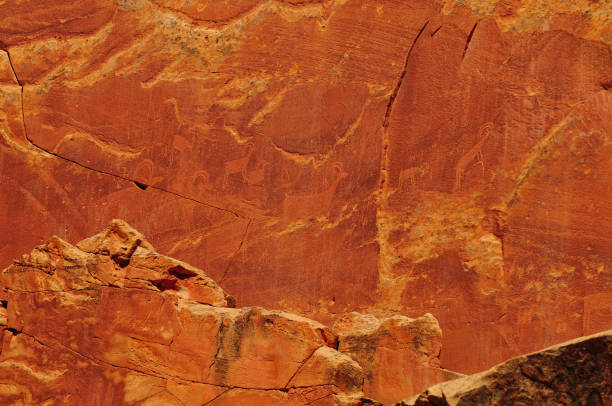 Fremont Culture Petroglyphs at Capitol Reef Fremont Culture Petroglyphs on a sandstone wall at Capitol Reef National Park, Utah, Southwest USA rock face stock pictures, royalty-free photos & images