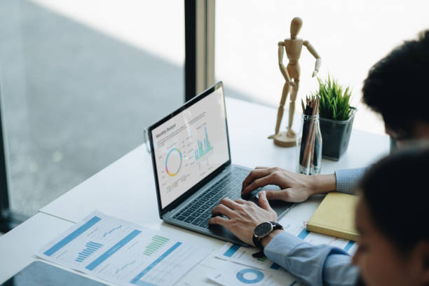 istock Businessman work with laptop at office, typing on keyboard. financial paperwork chart graph on desk 1395357965
