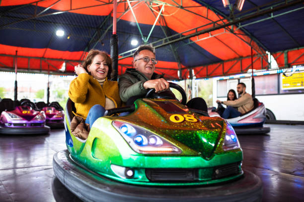 istock A playful mature couple having fun in a bumper car 1395358496