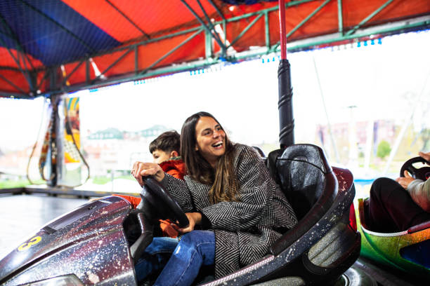 istock A young mom having fun driving her son in a bumper car 1395358507
