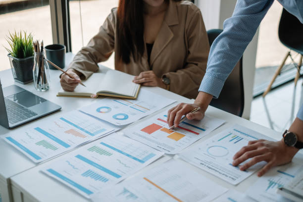istock Business Asian People Discussing with coworker planning analyzing financial document data charts and graphs in Meeting and successful teamwork Concept 1395358725