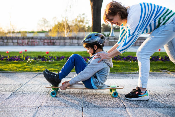 istock A cute boy and his grandmother having fun on a longboard 1395358822