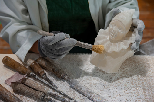 Working on alabaster sculpture. Various tools on the workbench.