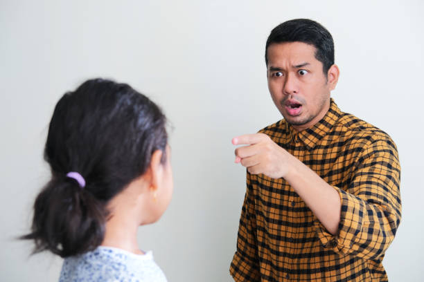 A father pointing finger to his daughter with angry expression A father pointing finger to his daughter with angry expression keluarga stock pictures, royalty-free photos & images