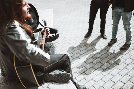 Side View Of Guitarist Playing Songs For Friends In Park