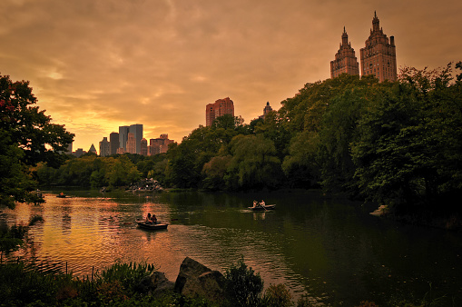 Row boats at sunset on a small lake in the Central Park, Upper West Side, New York City, NY, USA