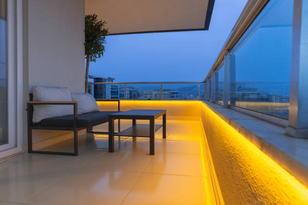 Large balcony of a luxury apartment. There is a small sofa with a coffee table.