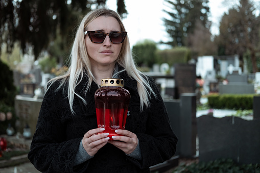 Woman wearing black dresses on cemetery