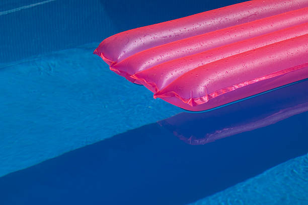 istock pink mattress in pool 139536223