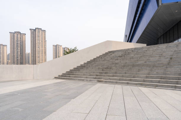 Empty stone squares and stone steps beside modern buildings