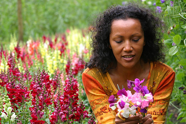 Beautiful dark woman in flower garden