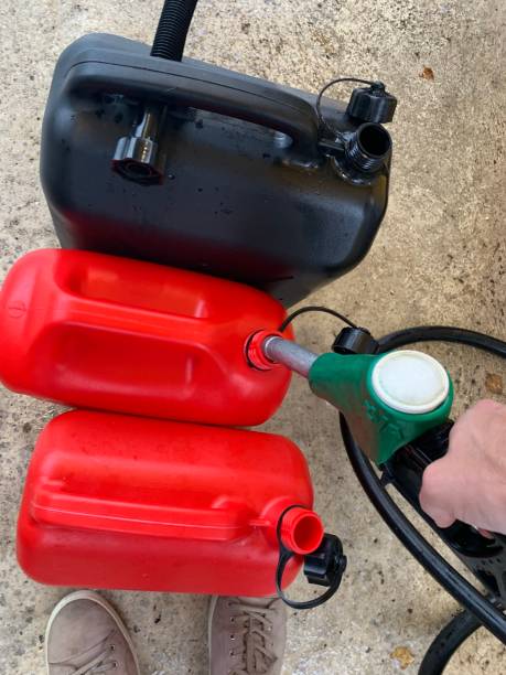 istock Filling gas cans at gas station 1395364766