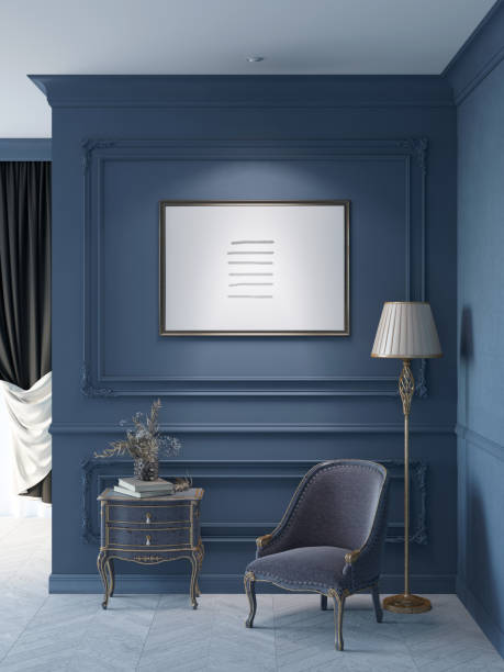 istock Dark blue classic interior with a horizontal poster on the wall with moldings, a floor lamp near a classic armchair, a vase of flowers on a stand, and a curtained window in the background. 1395365431