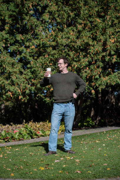 istock Confident Man with a coffee, squints in the sunlight. 1395367274