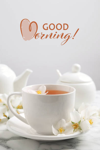 istock Aromatic jasmine tea and fresh flowers on white marble table. Good morning 1395367367