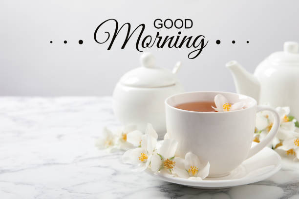 istock Aromatic jasmine tea and fresh flowers on white marble table. Good morning 1395367376