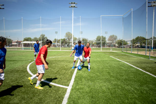 istock Friends playing soccer 1395367612