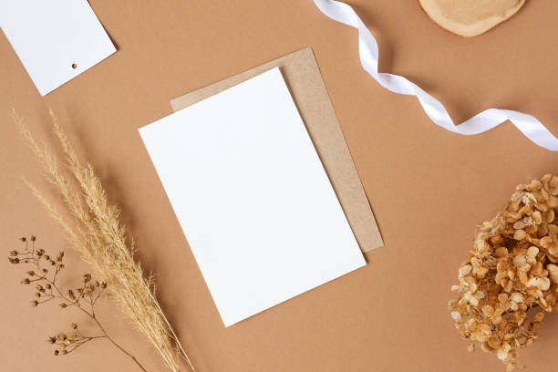istock Blank greeting card, invitation mockup. Dry grass, pampas plant on beige table background. Flat lay, top view. Copyspace. Paper cards, mock up. Modern Minimal business brand template. Soft shadow, A6 1395367840