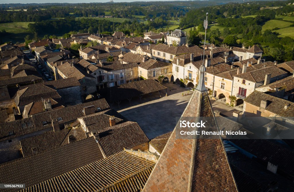 Aerial view of the village of Monpazier en Dordogne Aerial view of the Place de Cornières de Monpazier - In the foreground the bell tower of the Saint-Dominique church, Dordogne Rooster Stock Photo