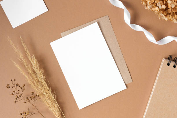 istock Blank greeting card, invitation mockup. Dry grass, pampas plant on beige table background. Flat lay, top view. Copyspace. Paper cards, mock up. Modern Minimal business brand template. Soft shadow, A6 1395367986