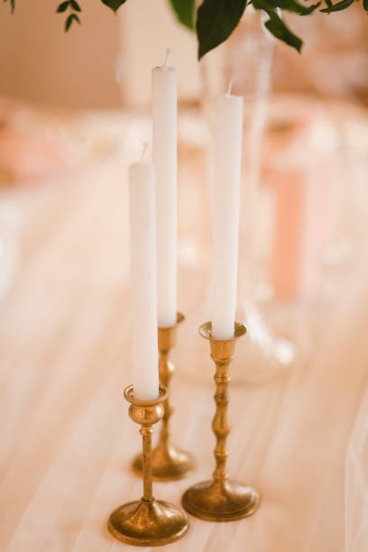 istock Table setting at the wedding reception. Floral compositions with beautiful flowers and greenery, candles, laying and plates on decorated table. 1395370722