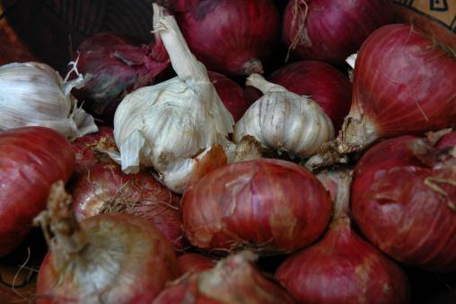 Bowl of garlic mixed with red onions.