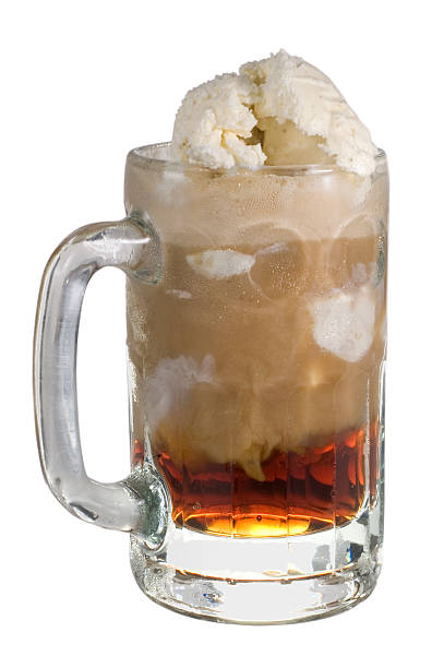 A close up of a root beer float in a glass mug