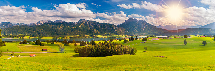 panoramic landscape in Bavaria with mountain range and lake