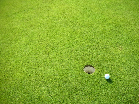 Close-up of a golf ball on a green