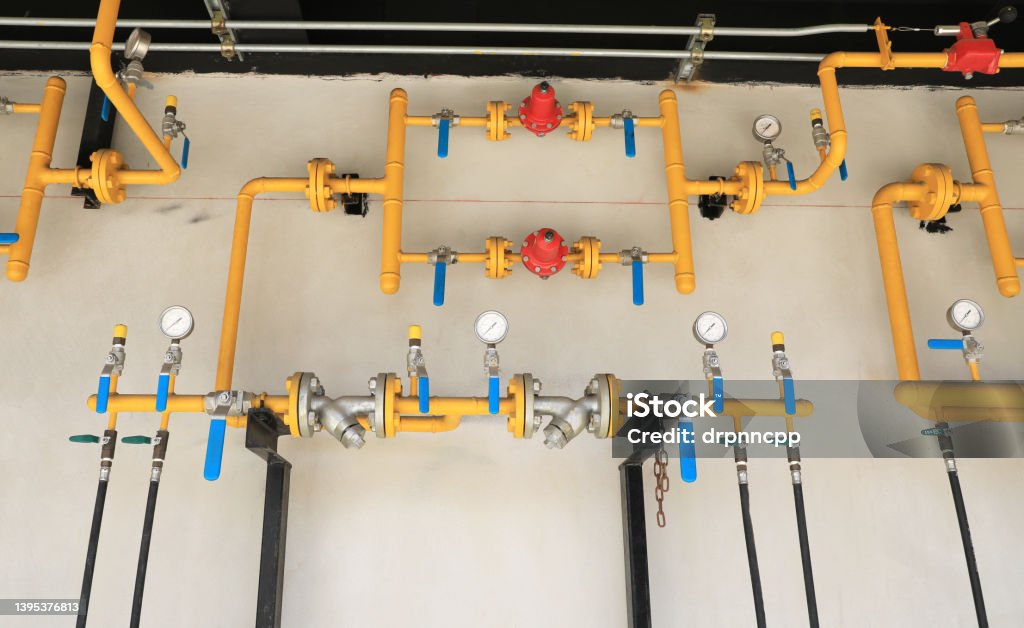 Yellow gas pipeline system installed on building wall. Color Image Stock Photo