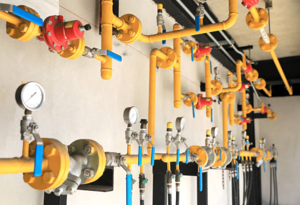 istock Yellow gas pipeline system installed on building wall. 1395376815
