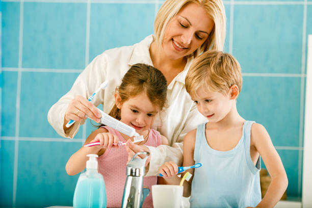 istock Family brushing teeth together in the bathroom 1395377833