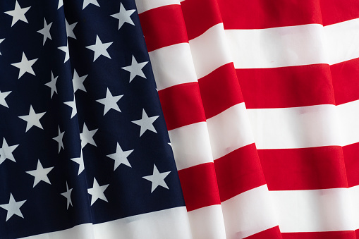 Top view of the American flag on a white background with copy space for text. Top view. Close-up photo