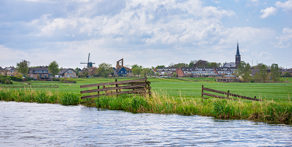 Rural view of meadows and the village of Hazerswoude-dorp in the west of the Netherlands.